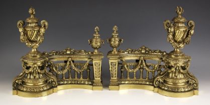 A pair of French brass fireside chenets, 20th century, each decorated with foliate swags and