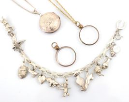 A selection of jewellery, including a white metal charm bracelet suspending various charms including