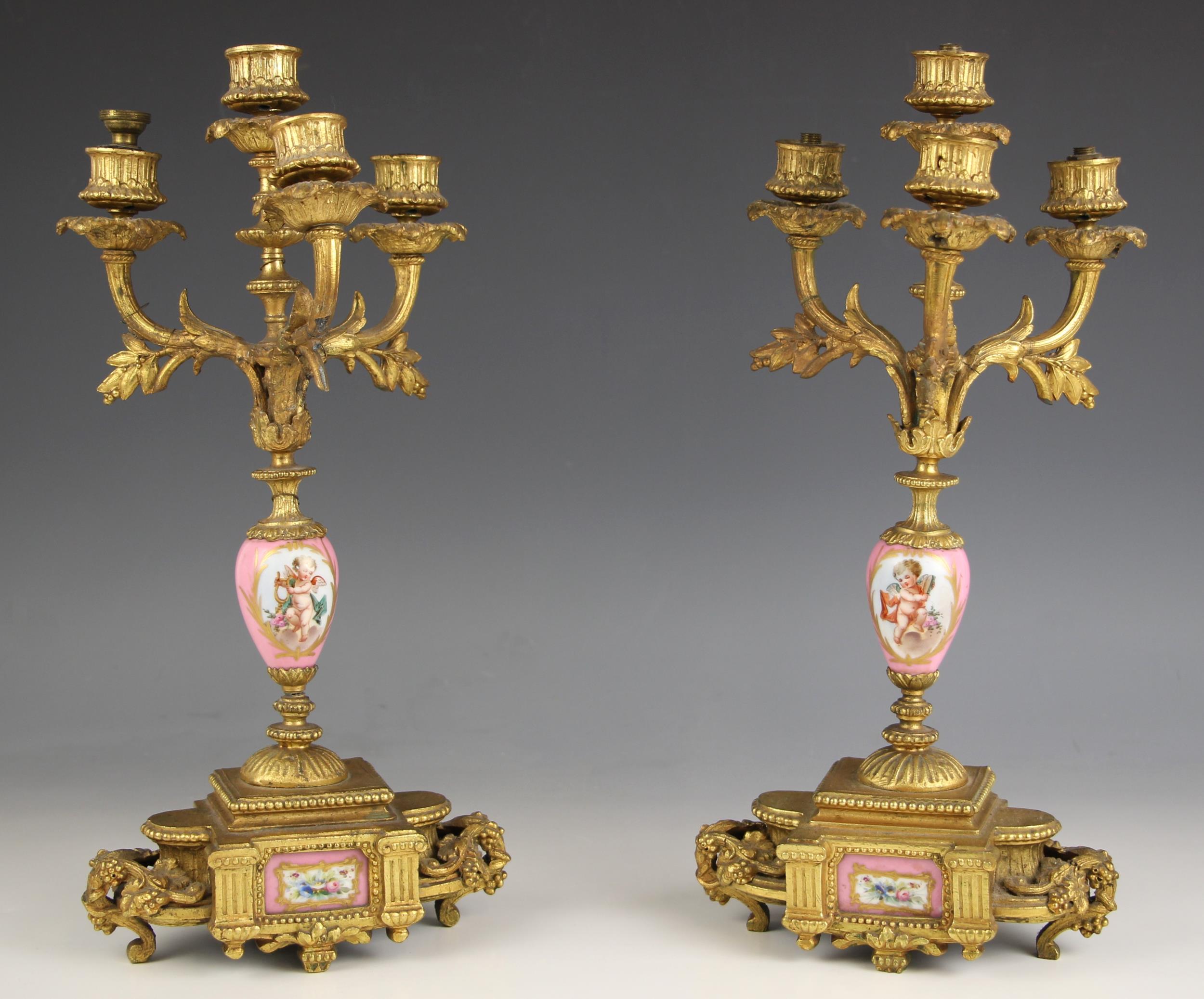 A pair of French porcelain and ormolu Rococo style candelabra, 19th century, the Sevres style