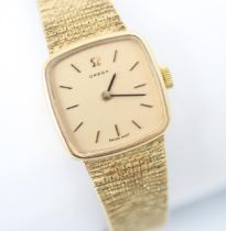 A yellow gold Omega ladies wrist watch, the square shaped gold coloured dial with baton markers, set