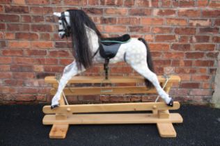 A painted wooden dapple grey rocking horse, late 20th century, applied with horse