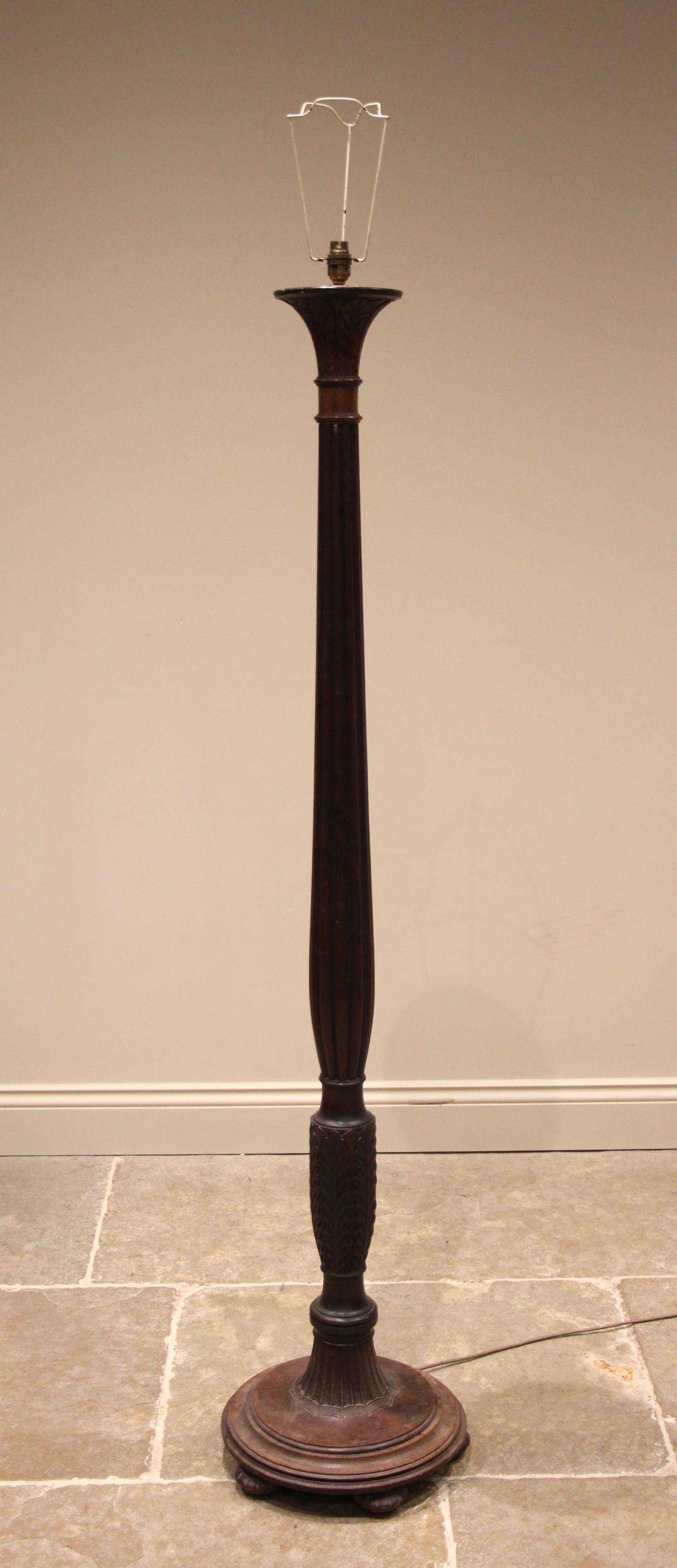 A Regency style mahogany standard lamp, early 20th century, the reeded acanthus column extending