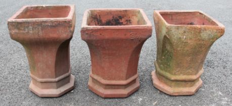 Three terracotta chimney planters, octagonal rims to canted sides and a square base, 43cm high,