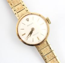 A ladies 9ct yellow gold Rolex Precision wristwatch, the circular white dial with baton markers, set