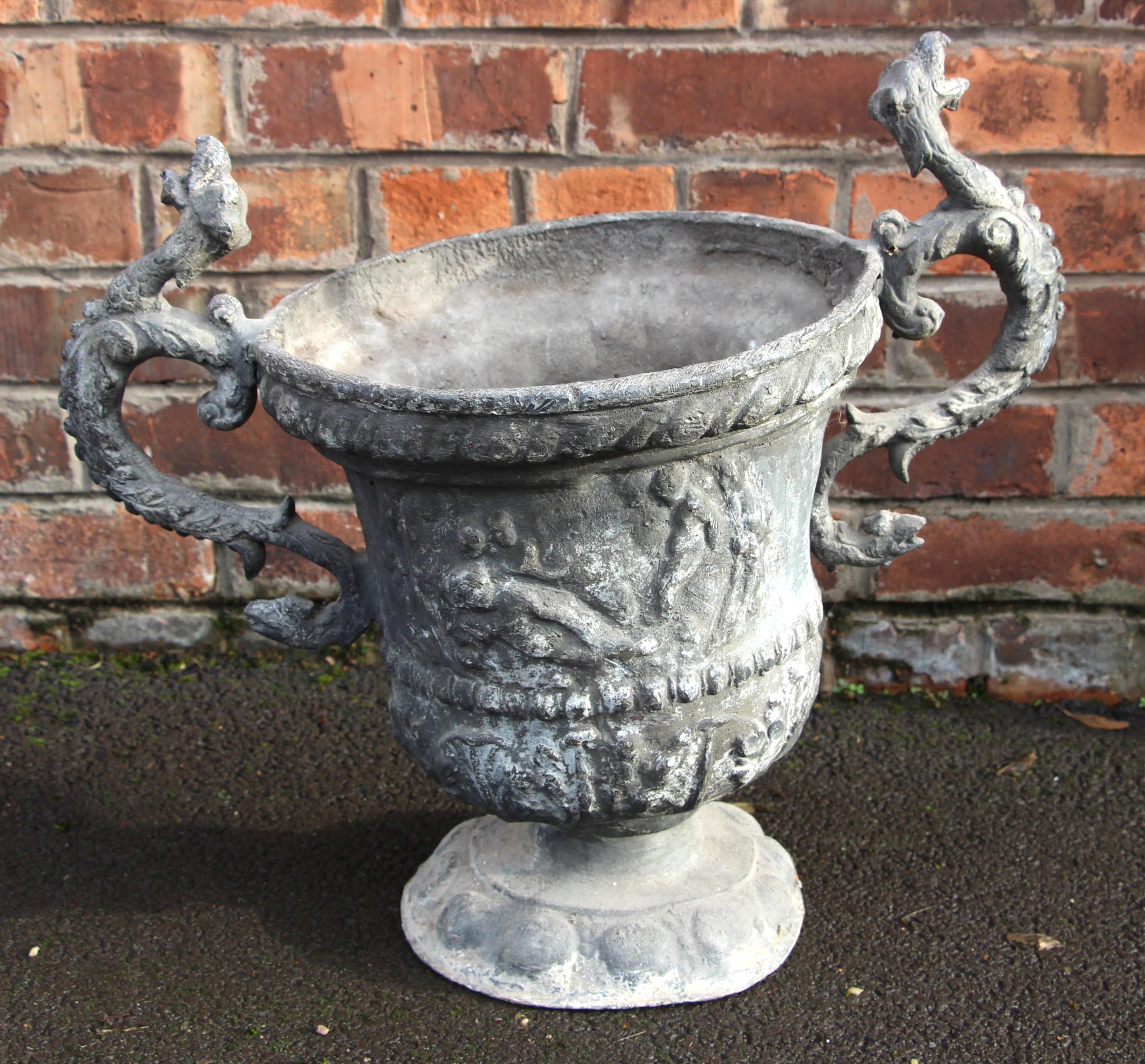 A lead urn planter, 19th century, of twin handled campana form, the body relief moulded with