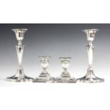 A pair of Edwardian silver candlesticks, Hawksworth, Eyre & Co Ltd, Sheffield 1902, the urn shaped