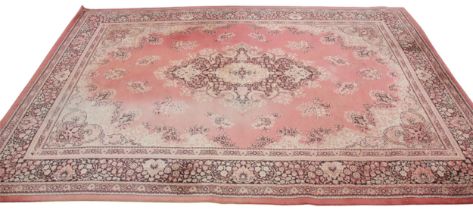 A Kashmir wool rug, the pink ground with a central foliate medallion and conforming spandrels, 250cm