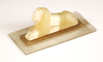 An Egyptian Grand Tour carved alabaster Sphinx, modelled upon a perspex base, carving 9.5cm long