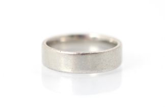 A palladium wedding band, stamped 'Pd 950', ring size R, 7gms