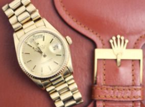 A gentleman's 18ct gold Rolex Oyster Perpetual Day-Date wristwatch, the round gold-toned dial with