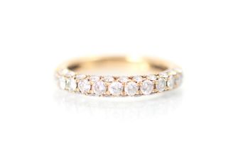 A rose gold diamond half eternity, the row of twelve round cut diamonds with eleven smaller round