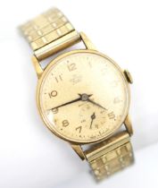 A Smiths Delux gentleman's yellow metal wristwatch, the cream coloured circular dial with Arabic