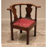 A 18th oak corner chair, the curved top rail upon a pair of shaped splats punctuated by ring