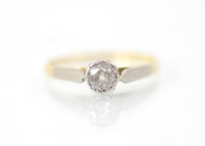 A 20th century diamond solitaire ring, the old cut diamond within white metal rub over mount with