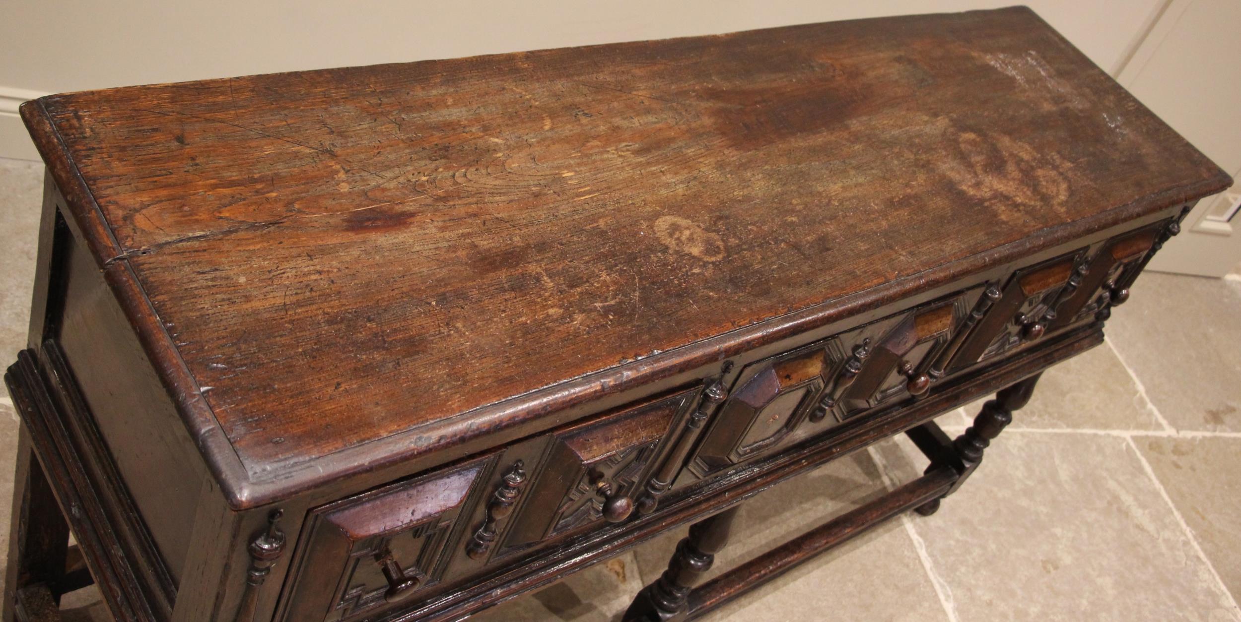 A Jacobean style oak sideboard, 17th century and later, the moulded plank top, over three frieze oak - Image 2 of 4