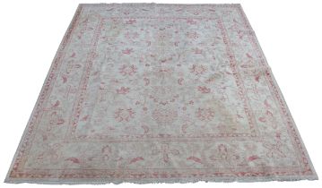 A Turkish Angora carpet, all over trailing foliate design in red and cream colourways, 300 L x 245cm