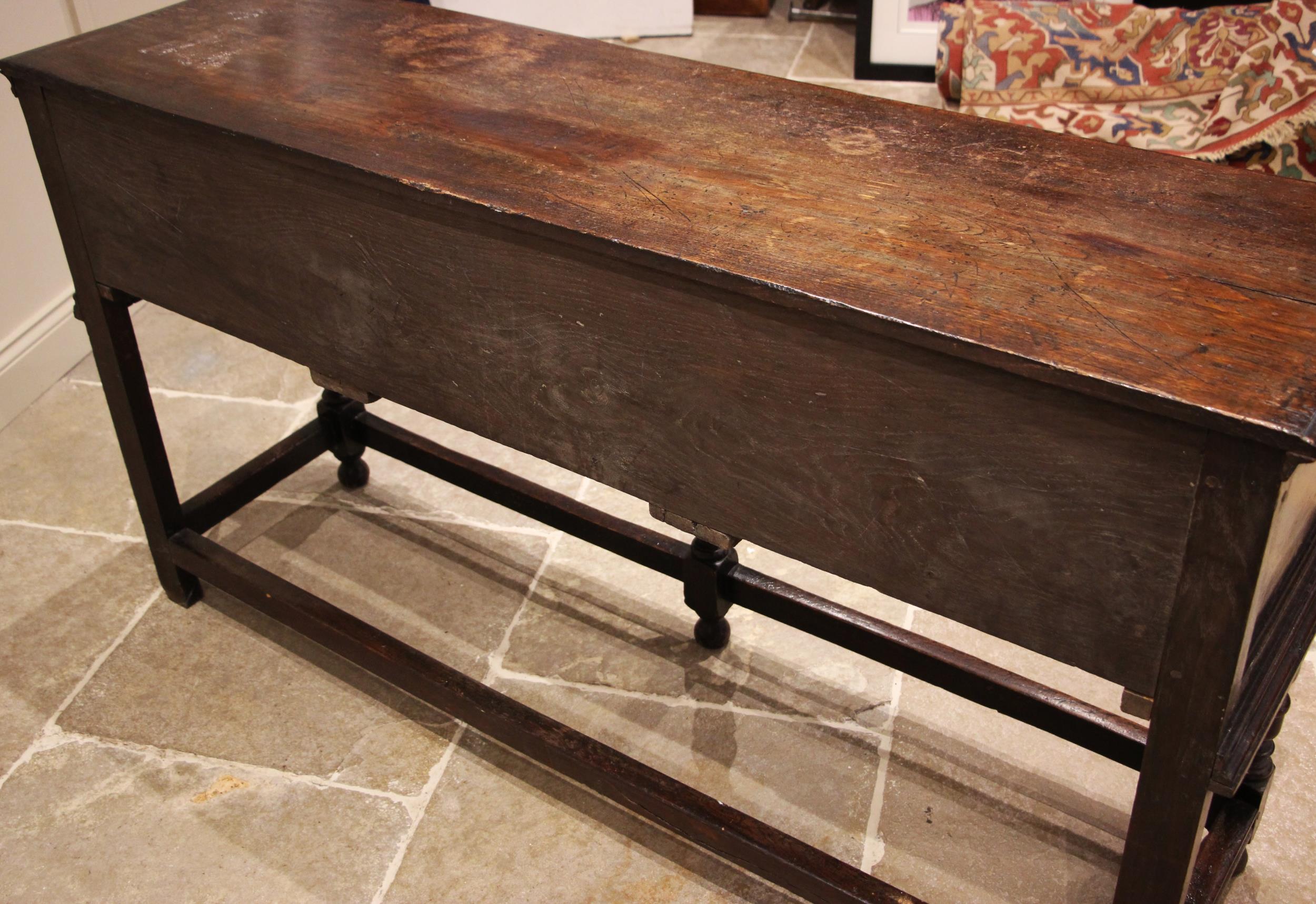 A Jacobean style oak sideboard, 17th century and later, the moulded plank top, over three frieze oak - Image 4 of 4