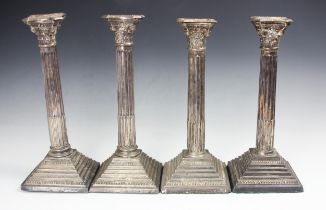 A pair of silver candlesticks, Roberts and Dore Ltd, London 1962, the cast floral terminals above