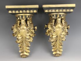 A pair of Egyptian Revival style painted wall brackets, 20th century, each modelled as a female