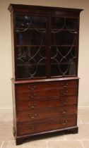 A George III mahogany secretaire bookcase, the cavetto cornice over a pair of 'shield' moulded