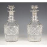 A pair of cut glass decanters, 19th century, each of mallet form, with triple knopped neck,