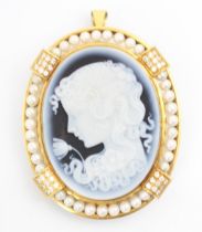 A Giovanni Apa cameo pendant or brooch, the oval blue and white cameo carved depicting young girl