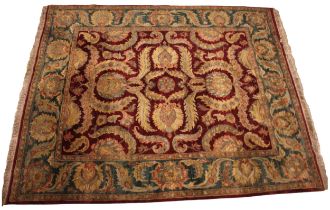 A Chinese thick pile wool rug, the central burgundy field with an all over foliate design,