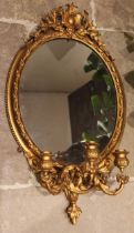 A 19th century giltwood and gesso girandole wall mirror, with an openwork foliate crest over the