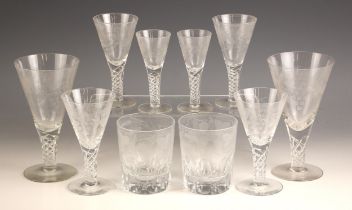 A part suite of glassware, each piece with funnel bowl etched with scrolling vines, upon an air
