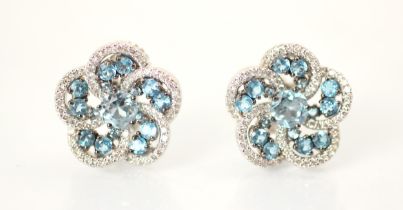 A pair of blue topaz and diamond cluster earrings, the central round cut blue stone with an open