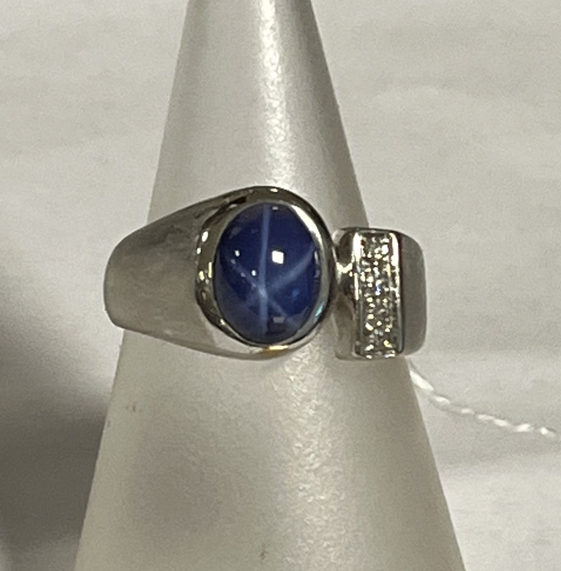 White gold ring with star sapphire and diamond