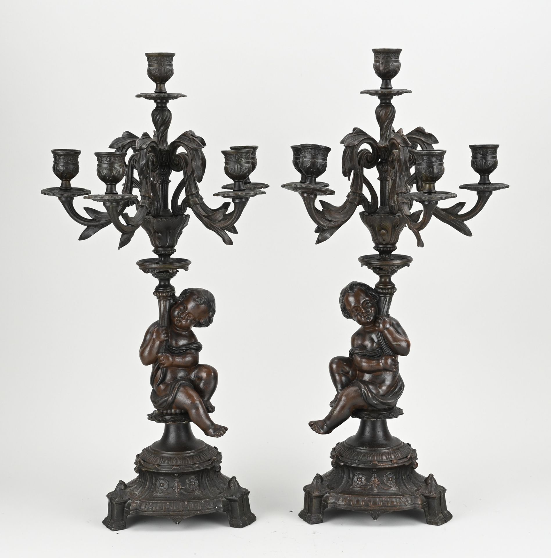 Two putti candlesticks, H 54 cm.