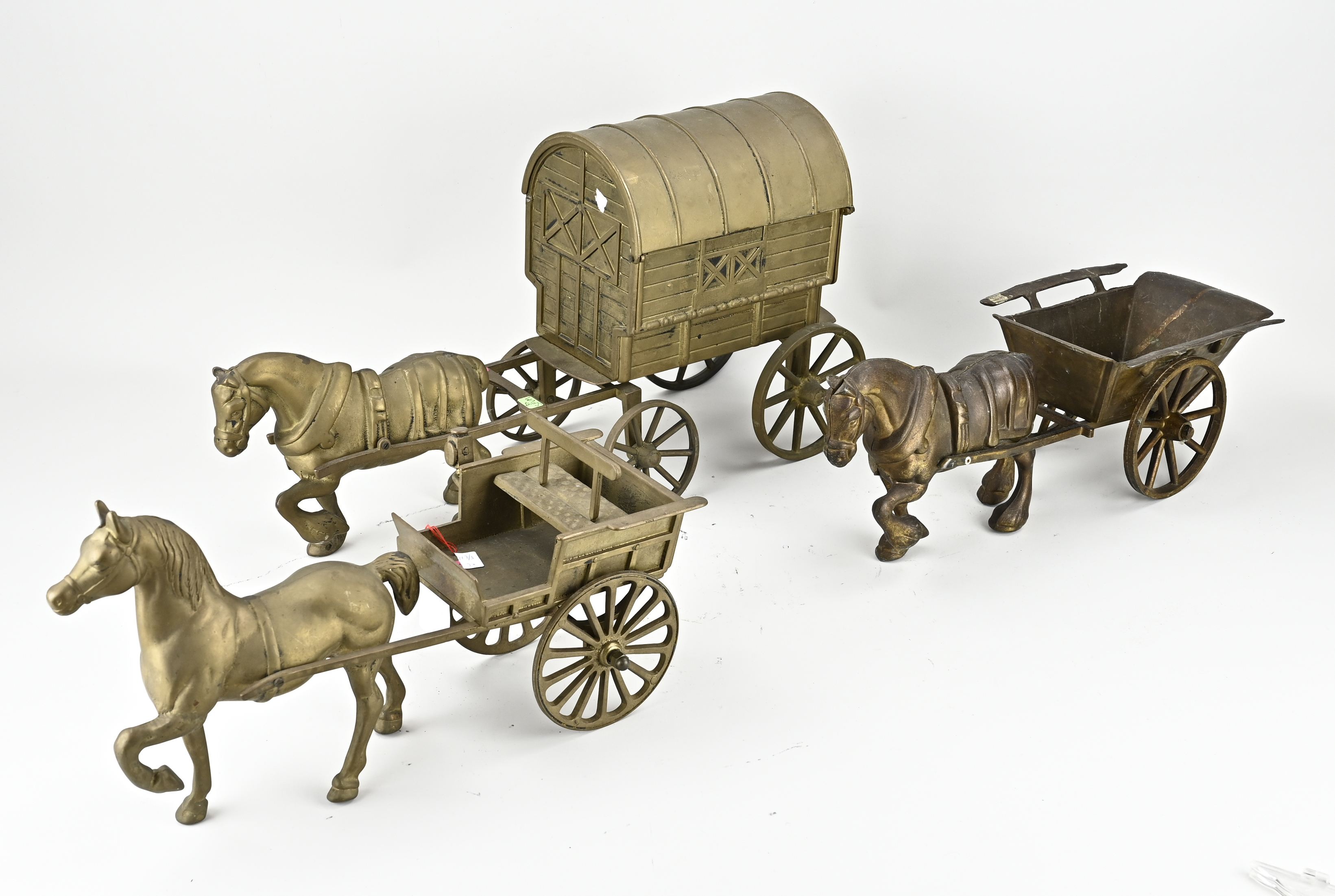 Three horses with a covered wagon