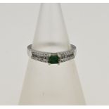 White gold ring with emerald and diamond