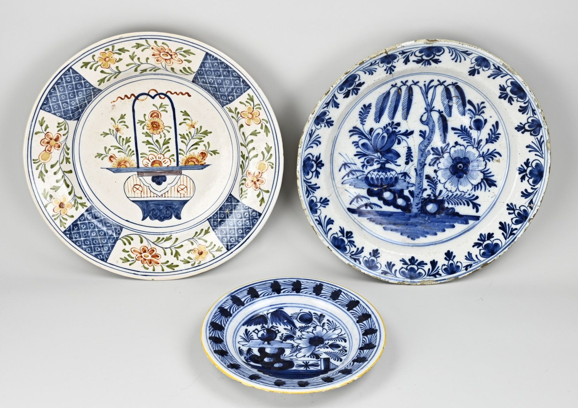 Three Delft dishes Ø 24 - 35 cm.