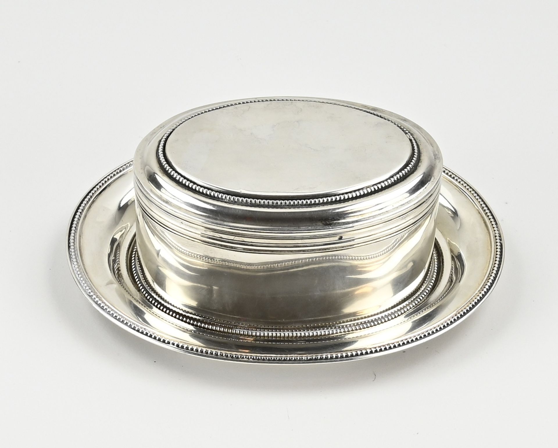 Silver biscuit tin with saucer