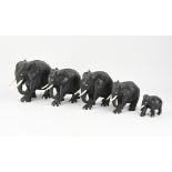 Five wooden elephants with bone