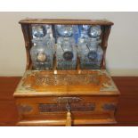 Edwardian Light Oak "After Dinner" Drinks Tantalus and Games Box, with three decanters and labels