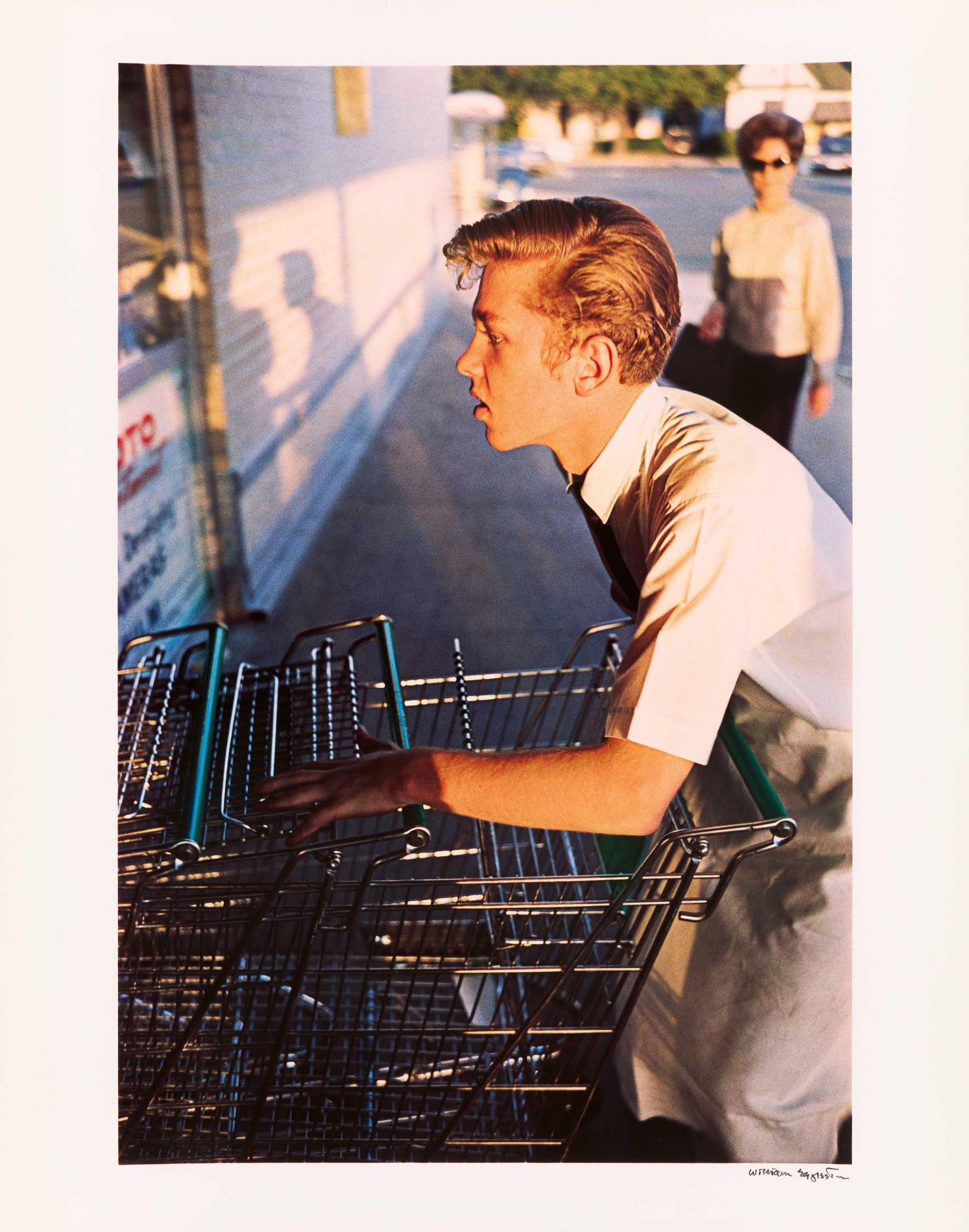 William Eggleston: Untitled (Supermarket Boy with Carts)