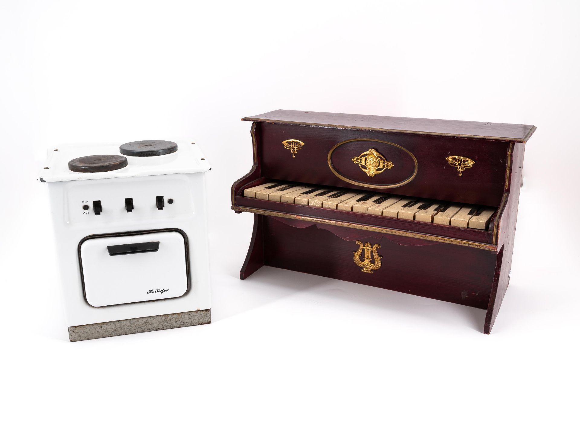 GermanyTOY PIANO MADE OF WOOD, BRASS AND PLASTIC AND A DOLL'S COOKING STOVE MADE OF SHEET METAL WITH