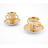Meissen: TWO PORCELAIN BEAKERS WITH DOUBLE HANDLE AND SAUCERS WITH GOLDEN CHINOISERIES