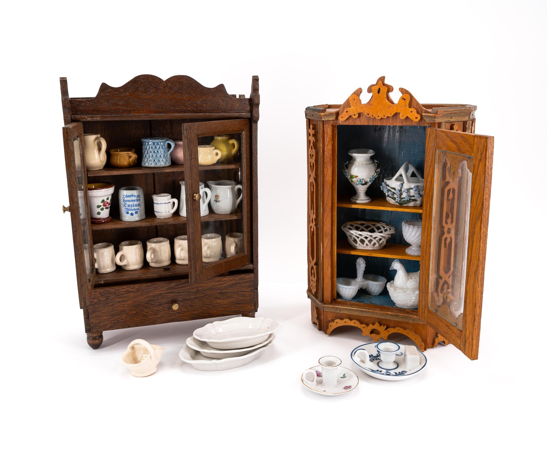 TWO MINIATURE CUPBOARDS WITH ALL KINDS OF TABLEWARE MADE OF WOOD, GLASS, METAL, RED CERAMIC AND PORC