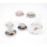 ENSEMBLE OF FIVE PORCELAIN MINIATURE CUPS AND SAUCERS WITH APPLIED FLOWERS