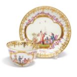 Meissen: PORCELAIN TEA BOWL AND SAUCER WITH CHINOISERIES IN CARTOUCHE WITH PURPLE LUSTRE
