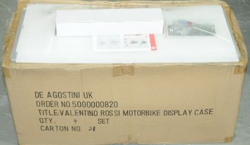 A trade box containing 4 Deagostini Valentino Rossi Motorbike display cases