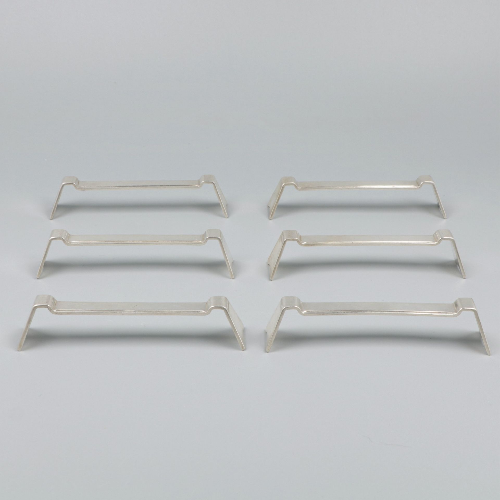 6-piece set of silver knife rests.