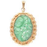 Vintage 14K yellow gold pendant set with green stone with floral cut designs.