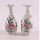 A pair of baluster-shaped vases with a contoured neck, Japan, 19th century. Polychrome floral decor,
