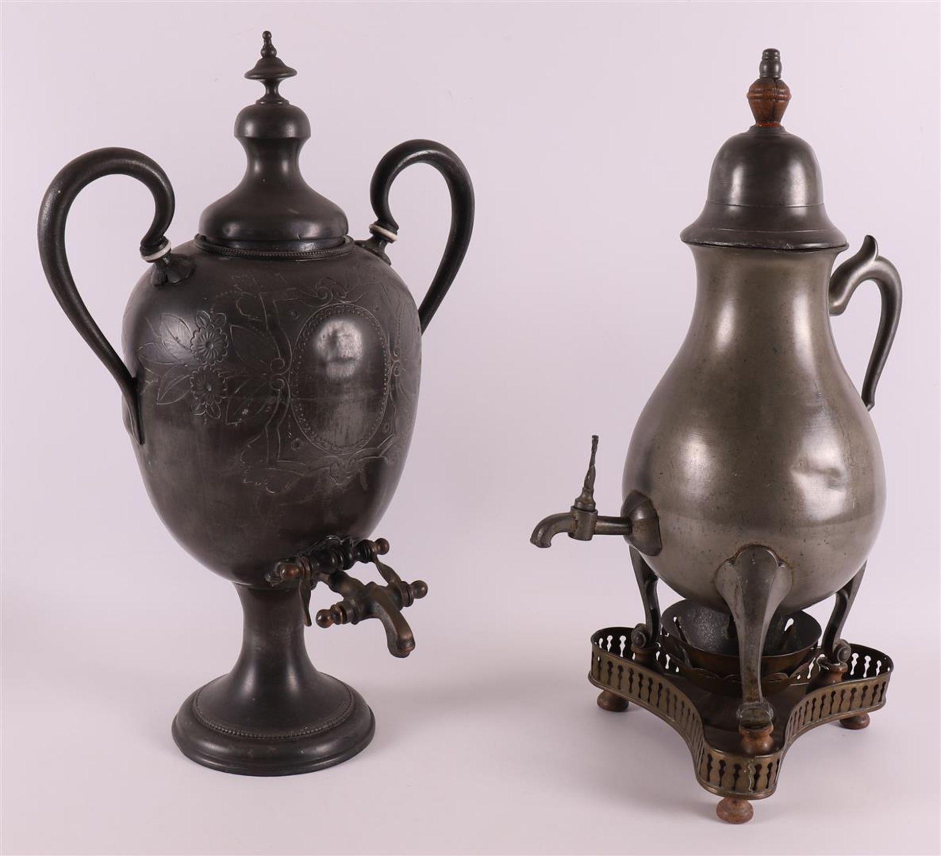 A white pewter pear-shaped tap jug, late 19th century. Resting on a copper/brass triangular brazier,