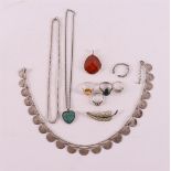 Various silver jewelry, including necklace and ring.